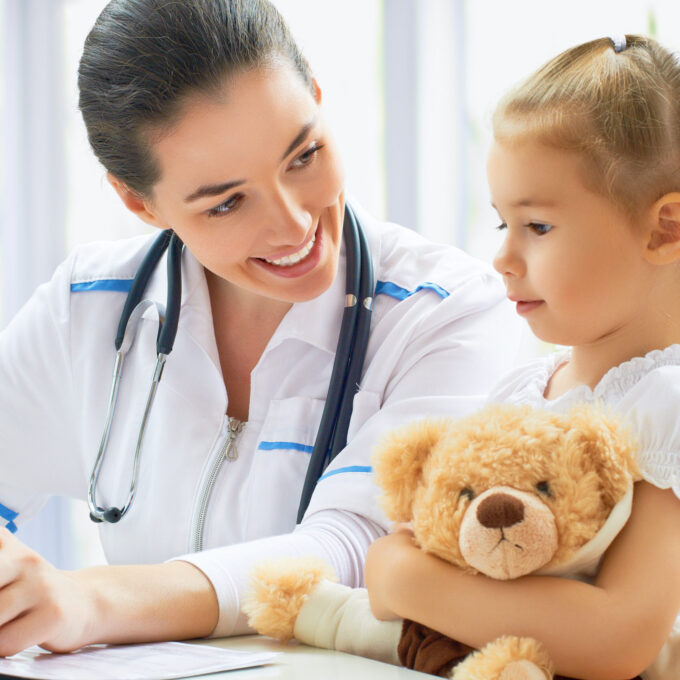 pediatrician doctor examining a child in a hospital